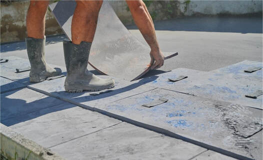 An image of a person working on a stamped concrete service